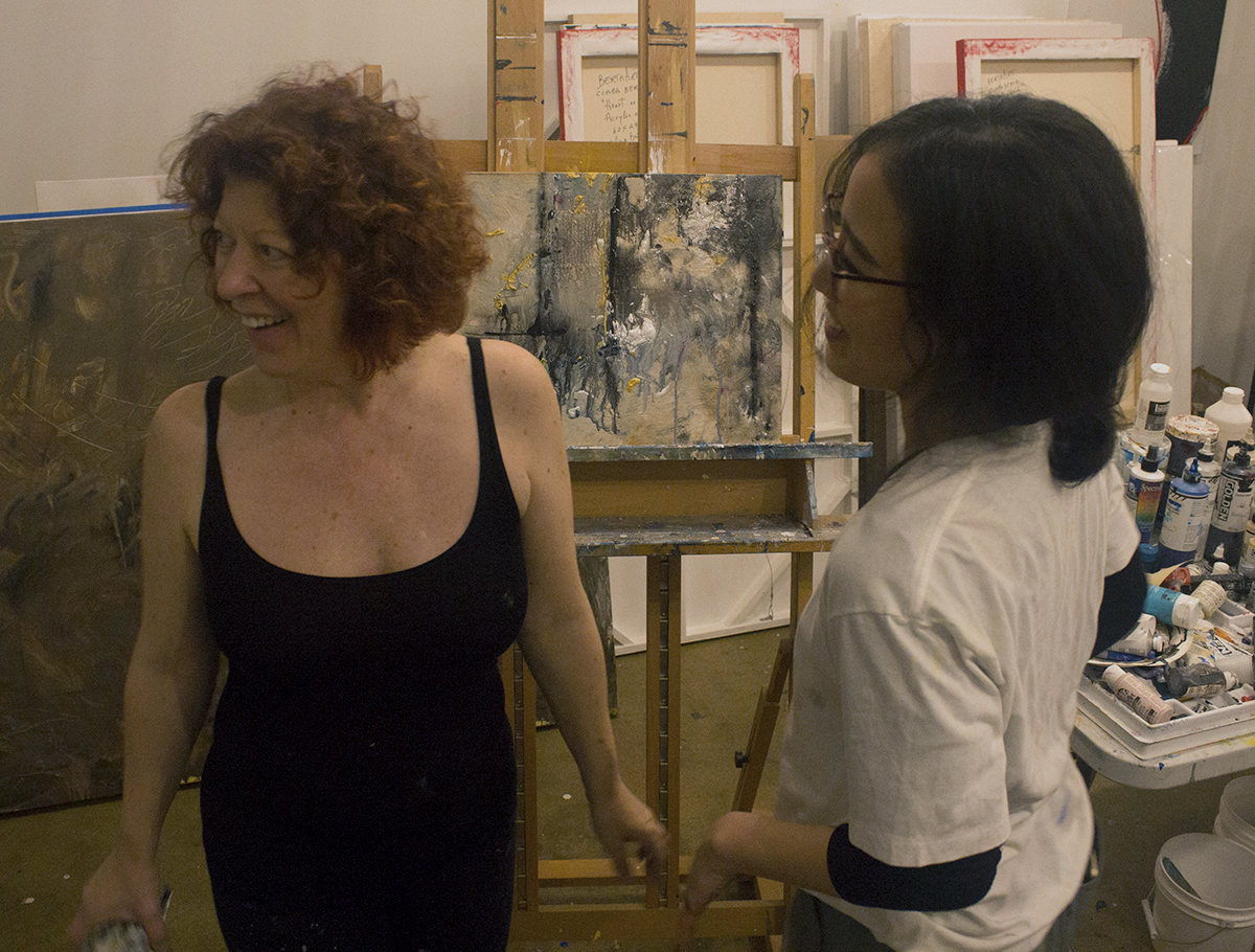 Clara Berta works with student at Yelp Ladies Night In art class