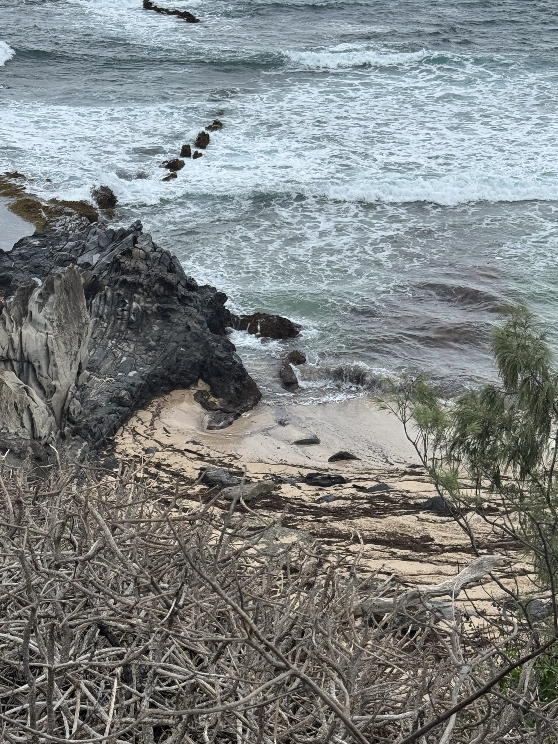 A rugged, winding 1.76-mile hiking trail through the Pe’ahi (Jaws) region of Maui, featuring lush green hills and volcanic cliffs overlooking the Pacific Ocean.