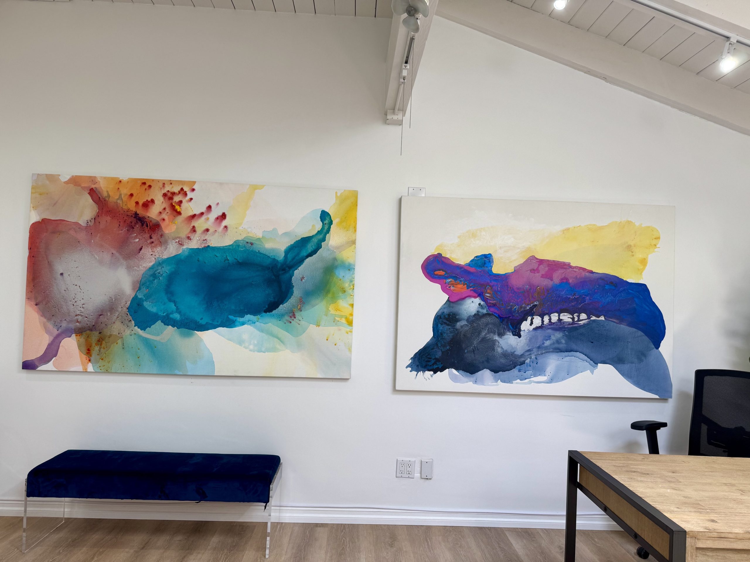 Large-scale fluid abstract painting by Clara Berta Studio featuring layered ocean blue, turquoise, and white acrylic textures that mimic moving water and sea waves.