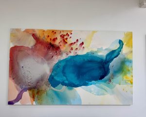 Large horizontal abstract painting titled Expansive Light by Clara Berta, featuring soft, luminous layers of white, light blue, and warm neutral tones on canvas.