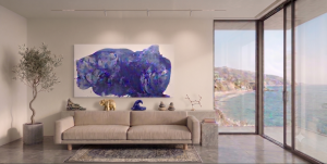 This modern abstract art features the large-scale Winter Solstice painting by Clara Berta above a neutral beige sofa. The 40x80 inch canvas is displayed in a luxury Laguna Beach living room with a textured concrete floor, potted olive tree, and floor-to-ceiling glass doors opening to sweeping ocean views.