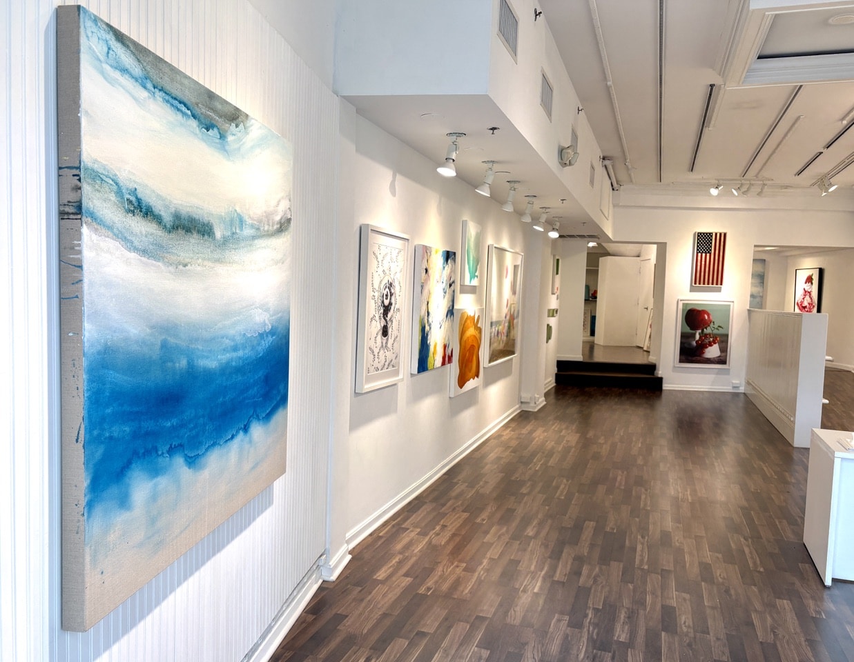 Entrance view of Beth Urdang Gallery showcasing abstract artwork and small canvas paintings by Clara Berta.