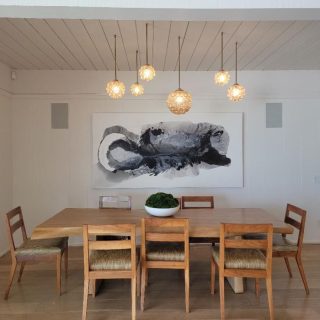'Magic' painting by Clara Berta, 48 x 96 in, installed in a collector's dining room. black and white flowing abstract painting by artist Clara Berta installed into an art collector's modern interior dining room.